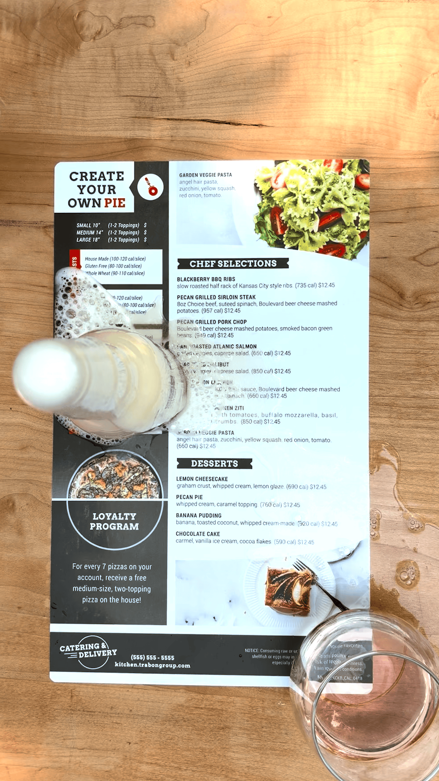 Waterproof restaurant menu with food and drink options on a wooden table.